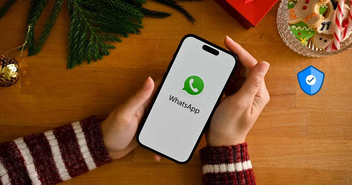 Person holding smartphone showing WhatsApp logo, highlighting WhatsApp Security during holiday season