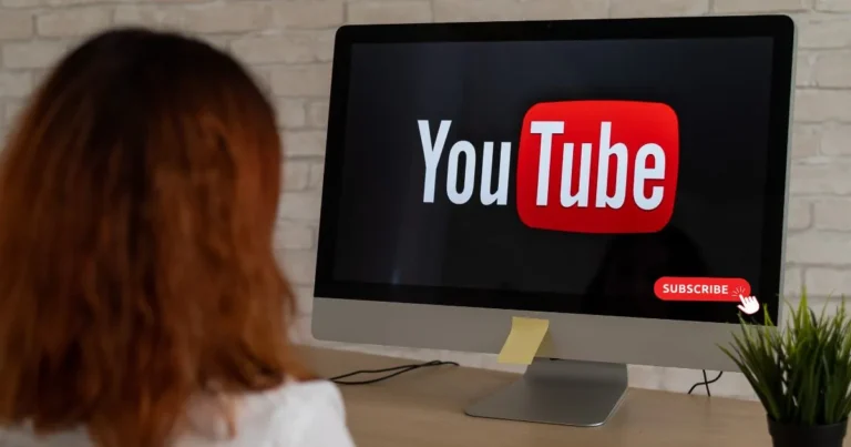 YouTube Security – Woman watching YouTube on a desktop with a subscribe button visible, symbolizing online engagement and potential privacy risks